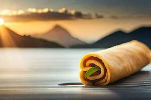 a roll of pasta on the table with mountains in the background. AI-Generated photo