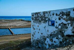 a window in a wall overlooking the ocean photo