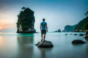 man standing on rocks at the beach at sunset. AI-Generated photo