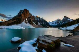 a lake surrounded by snow capped mountains at sunset. AI-Generated photo