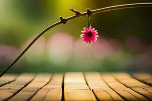 a pink flower hanging from a twig on a wooden table. AI-Generated photo