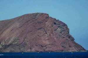 a large rock in the ocean photo