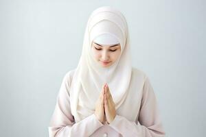 Hijab muslim woman praying with hands together isolated on white background AI Generated photo