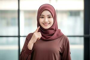 portrait of young muslim woman with hijab showing thumbs up gesture AI Generated photo