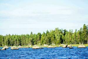 a lake surrounded by trees and rocks photo