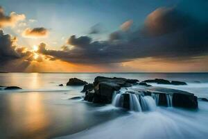 un hermosa puesta de sol terminado el Oceano con rocas y agua. generado por ai foto