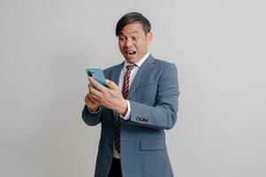 Businessman in a suit uses a mobile phone photo