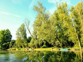 a lake with boats and trees photo