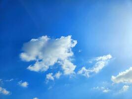 white clouds in the blue summer sky natural background photo