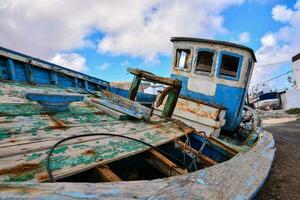 an old boat is sitting on the ground photo