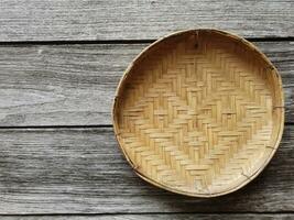 The light brown wooden basket looks beautiful as a wall decoration in the home or garden. photo