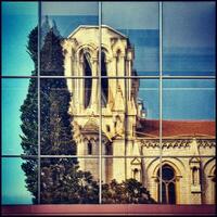 Notre Dame Basilica Nice Reflecting in Neighboring Building  Windows photo