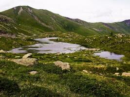 Serene Beauty Mountain Landscape with Small Blue Lake in Saint Sorlin d'Arves, Savoie photo