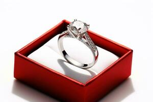 Wedding ring with large cut diamonds in red box on white background. Engagement ring in white gold or platinum with diamonds. Jewelry. For presentation, poster, banner, brochure AI generated photo