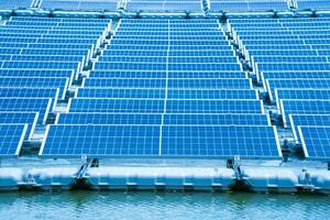Side view of solar panels floating on water in a lake, for generating electricity from sunlight, selective focus, soft focus. photo