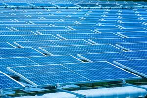 Side view of solar panels floating on water in a lake, for generating electricity from sunlight, selective focus, soft focus. photo