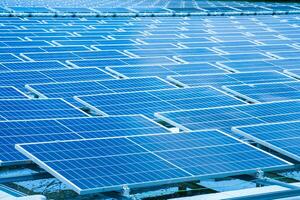 Side view of solar panels floating on water in a lake, for generating electricity from sunlight, selective focus, soft focus. photo