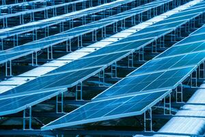 Side view of solar panels floating on water in a lake, for generating electricity from sunlight, selective focus, soft focus. photo