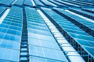 Side view of solar panels floating on water in a lake, for generating electricity from sunlight, selective focus, soft focus. photo