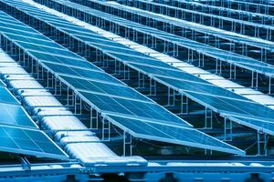 Side view of solar panels floating on water in a lake, for generating electricity from sunlight, selective focus, soft focus. photo