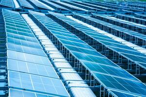 Side view of solar panels floating on water in a lake, for generating electricity from sunlight, selective focus, soft focus. photo