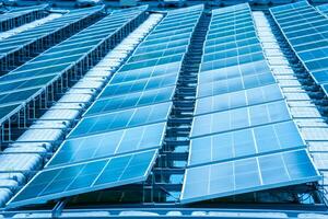 Side view of solar panels floating on water in a lake, for generating electricity from sunlight, selective focus, soft focus. photo