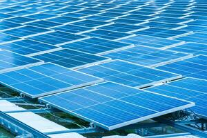 Side view of solar panels floating on water in a lake, for generating electricity from sunlight, selective focus, soft focus. photo