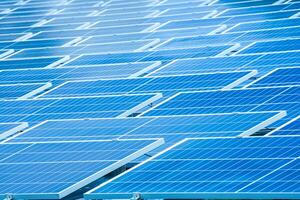 Side view of solar panels floating on water in a lake, for generating electricity from sunlight, selective focus, soft focus. photo