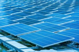 Side view of solar panels floating on water in a lake, for generating electricity from sunlight, selective focus, soft focus. photo