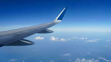 Airplane wing on a background of blue sky flight time photo