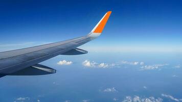 Airplane wing on a background of blue sky flight time photo