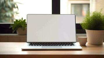 Modern laptop with blank white screen on the table photo