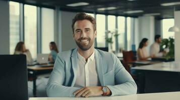 Confident professional man at office desk, smiling into the camera, bathed in daylight photo