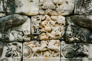 carvings on the wall of an ancient building photo