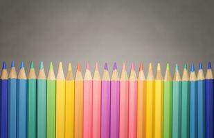 collection of color pencild laying in row striaght line grey background close up, Color pancils, copy space, Pastel color concept, Office and school equipment, Education concept photo