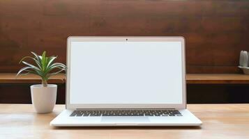 Modern laptop with blank white screen on the table photo