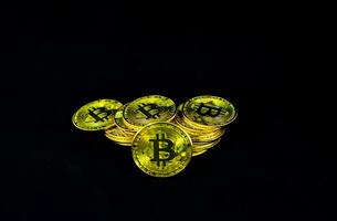 Plie of golden bitcoin, Bitcoin on  black background. Business and finance concept. photo