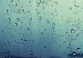 Beautiful raindrops on a window, Raindrops Or Vapor Trough on the glass, Abstract of raindrops on the mirror with a colored background. Drops of water - Image photo