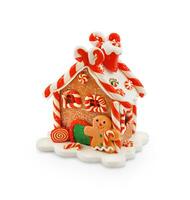 Gingerbread house decorated with sweets isolated on white background photo