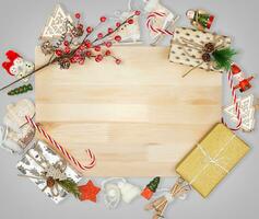 Christmas decorations on gray and wooden background photo