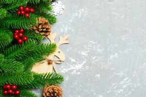 Top view of Christmas background made of fir tree and decorations on cement background. New year holiday concept with copy space photo