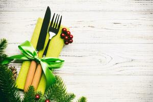 Top view of festive cutlery on new year wooden background. Christmas decorations with empty space for your design. Holiday dinner concept photo