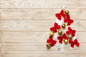Christmas tree made from colored ball decoration on colored background, view from above. New Year minimal concept with copy space photo