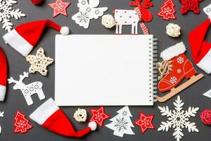 Top view of notebook. New Year decorations on black background. Merry Christmas concept photo