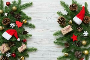 Christmas decorations and fir tree branch and gift boxon dark table. Top view frame with copy space photo