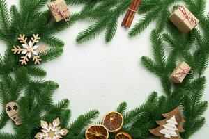 Christmas decorations and fir tree branch and gift boxon dark table. Top view frame with copy space photo