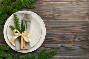 Christmas table place setting with christmas decor and plates, kine, fork and spoon. Christmas holiday background. Top view with copy space photo