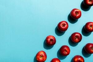 Many red apples on colored background, top view. Autumn pattern with fresh apple above view photo