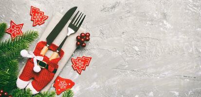 Top view Banner of festive cutlery on new year cement background. Christmas decorations with empty space for your design. Holiday dinner concept photo