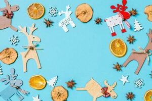 Top view of holiday decorations and toys on blue background. Christmas ornament concept with empty space for your design photo